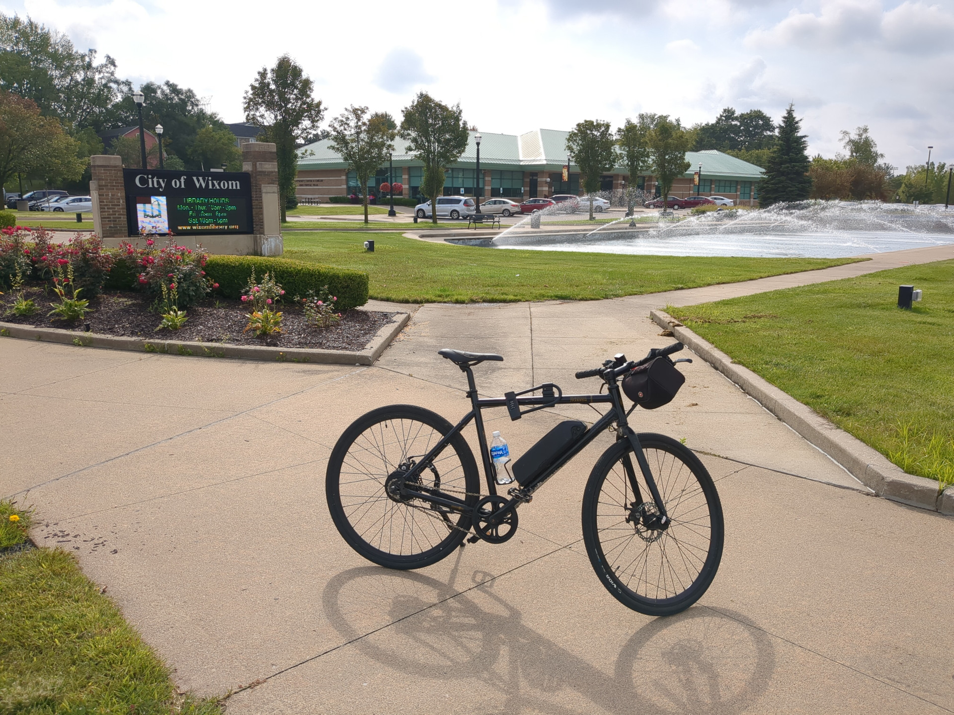 My bike sits in front of a fountain in front of the Wixom Public Library