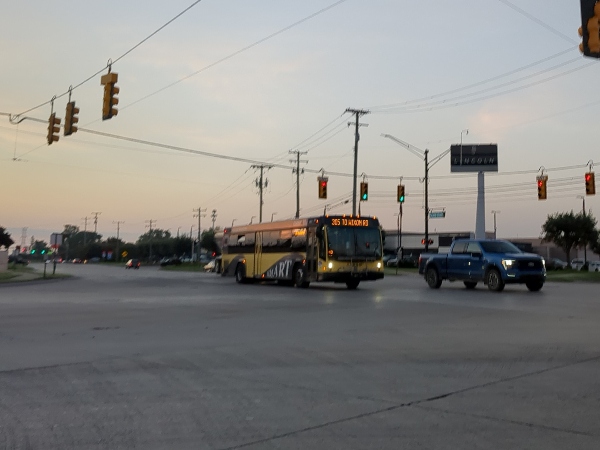A 305 Grand River bus crossing Wixom Road